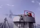 
An Iranian navy seaman fires atop a warship during a joint military drill in the Indian Ocean in January 2022. The Iranian navy has fired at or harassed nearly 20 international vessels since 2021. [Iranian army office/AFP]        