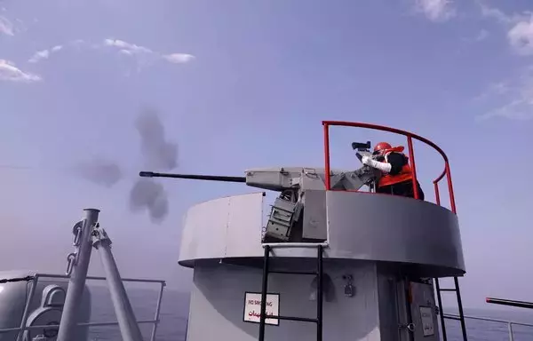 An Iranian navy seaman fires atop a warship during a joint military drill in the Indian Ocean in January 2022. The Iranian navy has fired at or harassed nearly 20 international vessels since 2021. [Iranian army office/AFP]