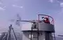 
An Iranian navy seaman fires atop a warship during a joint military drill in the Indian Ocean in January 2022. The Iranian navy has fired at or harassed nearly 20 international vessels since 2021. [Iranian army office/AFP]        