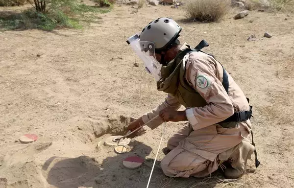 A member of Yemen's pro-government forces prepares a mine for remote detonation in the village of Hays in Yemen's western province of al-Hodeidah on August 11. [Khaled Ziad/AFP]