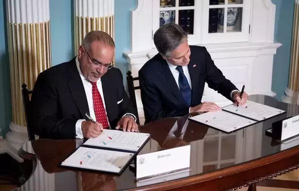 Bahrain's Prime Minister and Crown Prince Salman bin Hamad Al Khalifa and US Secretary of State Antony Blinken sign a security integration and prosperity agreement at the US Department of State on September 13 in Washington, DC. [Brendan Smialowski/AFP]