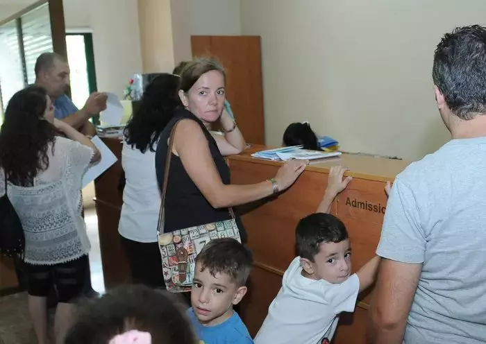 Families wait to enroll their children at a private school in Lebanon. [Naji Akram/Al-Fassel]