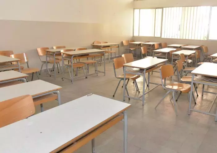 Empty desks and chairs await the arrival of students at a school in Lebanon. [Naji Akram/Al-Fassel]