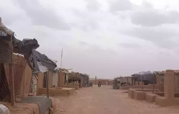 A motorcyclist rides down a dusty street in al-Rukban camp in southern Syria on August 13. [Civilian Affairs Authority in al-Rukban Camp and Badiya]