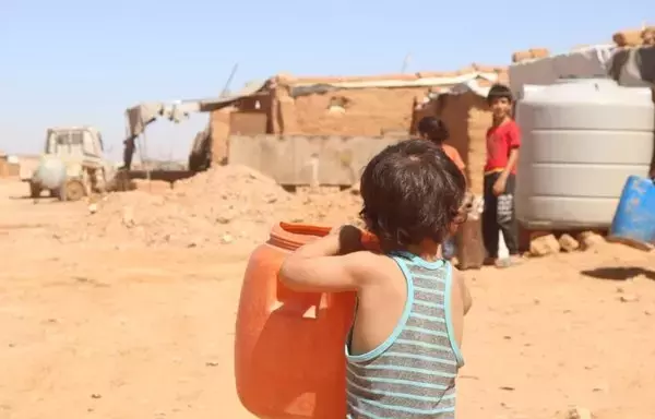 Children in al-Rukban camp, seen here fetching water on August 23, are deeply affected by the siege imposed by Syrian regime forces. [Al-Rukban Media Center]