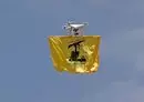 
A drone carries the flag of Lebanese Hizbullah above Aarmata bordering Israel on May 21. The Iran-backed party simulated cross-border raids into Israel in a show of its military might, using live ammunition and an attack drone. [Anwar Amro/AFP]        