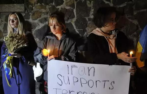 People demonstrate outside the Iranian embassy in Kyiv, Ukraine, on October 17, after the city was hit by swarms of kamikaze drones that Iran sold to Russia. [Sergei Chuzavkov/AFP]