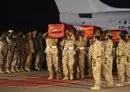 
Members of the Bahraini armed forces on September 5, 2015, carry the coffins of comrades killed during the battle against the Houthis during an official repatriation ceremony at Isa air base in Sakhir, south of Manama. [Mohammed al-Shaikh/AFP]        