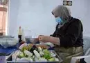 
A woman prepares food inside the kitchen of the women-run catering service Taste of Mosul on September 13. [Zaid al-Obeidi/AFP]        