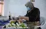 
A woman prepares food inside the kitchen of the women-run catering service Taste of Mosul on September 13. [Zaid al-Obeidi/AFP]        