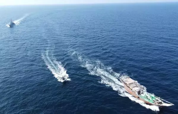 US service members from patrol coastal ship USS Typhoon interdict a stateless fishing vessel carrying illicit weapons while transiting international waters in the North Arabian Sea, December 20, 2021. [US Navy]