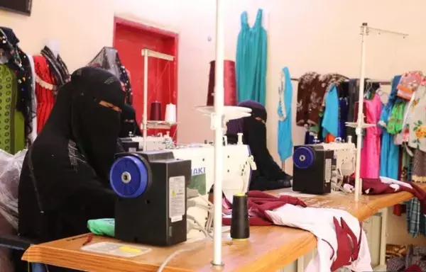 Two women stitch garments at the sewing craft factory, funded by the Saudi Development and Reconstruction Program for Yemen. [Saudi Development and Reconstruction Program for Yemen]