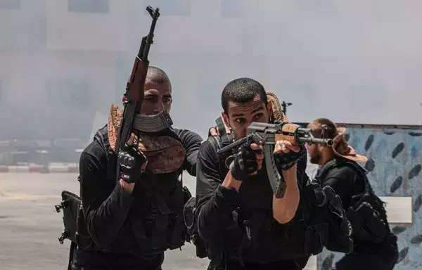 Members of a police academy run by the Palestinian Hamas movement take part in a training session in the town of Khan Yunis in the southern Gaza Strip on August 2. [Said Khatib/AFP]