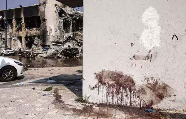 Blood stains a wall at an Israeli police station in Sderot after it was damaged during battles to dislodge Hamas militants who were stationed inside, on October 8. [Ronaldo Schemidt/AFP]