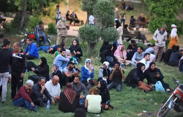 Syrians await the release of relatives held in regime prisons, on May 3, 2022, in the center of Damascus, after a general amnesty was issued. [Louai Beshara/AFP]