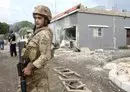 
A soldier stands guard outside a house on the outskirts of the southern Lebanese border village of Dhayra on October 11 after Lebanese Hizbullah and Israel exchanged fire. [Mahmoud Zayyat/AFP]        