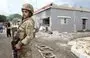 
A soldier stands guard outside a house on the outskirts of the southern Lebanese border village of Dhayra on October 11 after Lebanese Hizbullah and Israel exchanged fire. [Mahmoud Zayyat/AFP]        