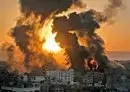 
A fire rages at sunrise in Khan Yunish following an Israeli air strike in southern Gaza strip. [Youssef Massoud]        