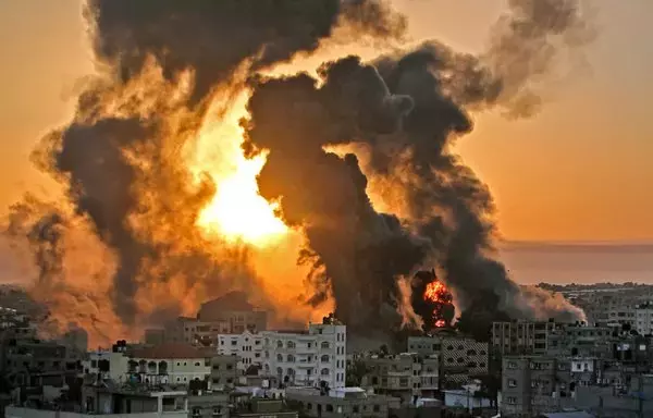 A fire rages at sunrise in Khan Yunish following an Israeli air strike in southern Gaza strip. [Youssef Massoud]