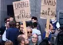 
A woman holds placards reading 'Hamas=Daesh (ISIS)' and in French 'free the hostages' during a tribute to the victims of the Hamas-organized attacks in Israel, at the European Parliament in Brussels, on October 11. [Kenzo Tribouillard/AFP]        