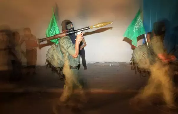 Hamas militants march through the streets of Gaza City on October 1, 2012, as they take part in night training, where they march for many hours carrying various weapons. [Mahmud Hams/AFP]