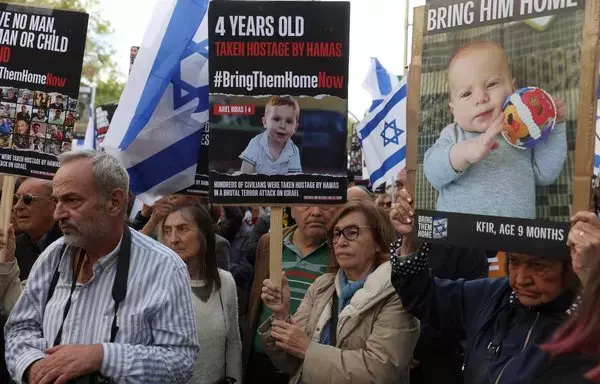 Members of the Federation of Jewish Communities of Spain hold pictures of hostages as they call for the liberation of the hostages held by Hamas, in front of the Congress of Deputies in Madrid on October 22. [Pierre-Philippe Marcou/AFP]