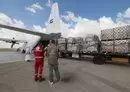 
Staff members unload aid for the Gaza strip from an Emirates cargo plane on the tarmac of Egypt's al-Arish airport in north Sinai on October 19. [Giuseppe Cacace/AFP]        