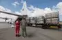 
Staff members unload aid for the Gaza strip from an Emirates cargo plane on the tarmac of Egypt's al-Arish airport in north Sinai on October 19. [Giuseppe Cacace/AFP]        