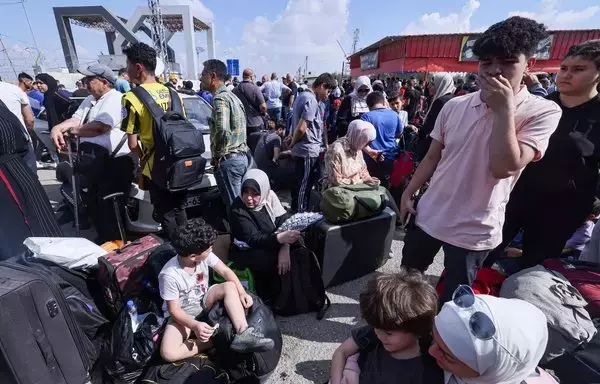 Shown are Palestinians, some with foreign passports, hoping to cross into Egypt and others waiting for aid at the Rafah crossing in the southern Gaza strip, on October 16. [Mohammed Abed/AFP]