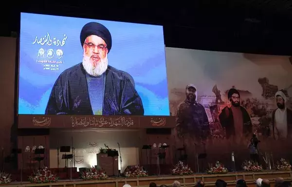 Supporters of Hizbullah attend a televised speech by the group's leader Hassan Nasrallah in Beirut's southern suburb, on February 16. [Anwar Amro/AFP]