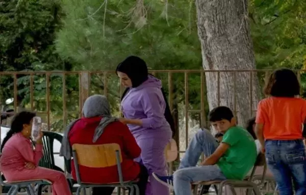 Women and children displaced from southern Lebanon sit in the courtyard of the Lebanese University's Faculty of Science in Tyre. [Ziyad Hatem/Al-Fassel]