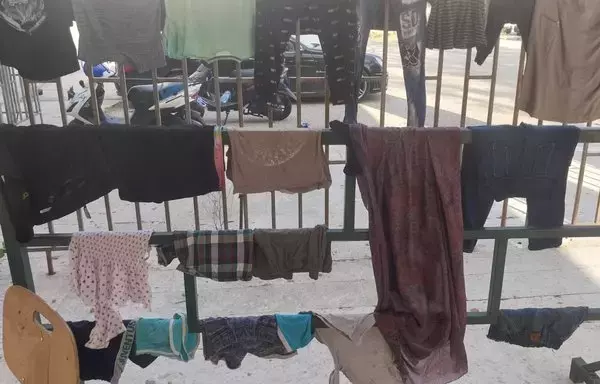 Laundry hangs at the entrance to the Lebanese University's Faculty of Science in Tyre, which has turned into a shelter for families who left their border villages in southern Lebanon. [Janoub Sweid]