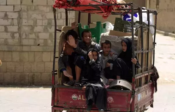 Children are transported in the back of a small truck in the northern Yemen province of Amran on July 6, 2019. Amran, a strategic gateway to Sanaa, was taken by the Iran-backed Houthis on July 8, 2014. [Mohammed Huwais/AFP]