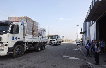 Dozens of aid trucks enter Gaza as US says Israel must protect Palestinian civilians