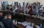 
Palestinian border guards check the documents of people leaving Gaza as dual national Palestinians and foreigners prepare to cross the Rafah border point with Egypt on November 2. [Said Khatib/AFP]        