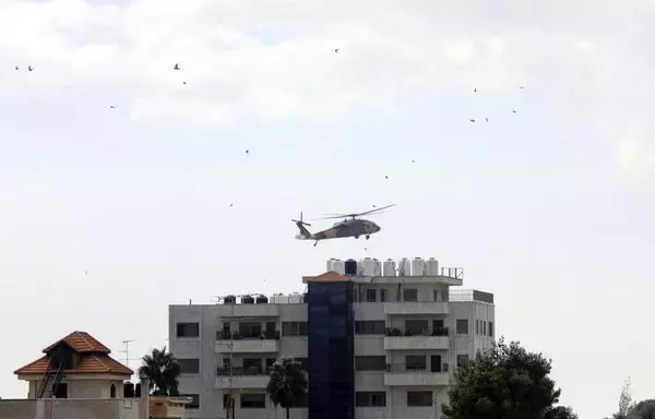 A helicopter carrying the Cypriot foreign minister approaches the headquarters of the Palestinian Authority in Ramallah in the West Bank, on October 30 amid ongoing battles between Israel and Hamas. [Zain Jaafar/AFP]