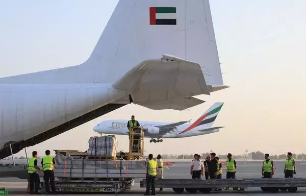 An Emirates cargo plane is loaded with aid for Gaza at the airport in Dubai before flying to the city of al-Arish in Egypt’s North Sinai province on October 17. [Karim Sahib/AFP]