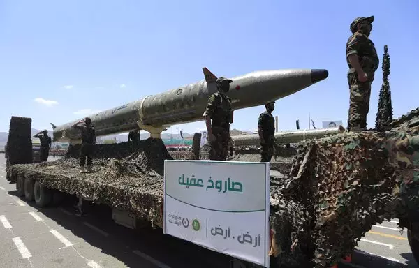 Houthi fighters stand on a missile carrier during a September 21 military parade in Sanaa marking the ninth anniversary of the group's coup. [Mohammed Huwais/AFP]