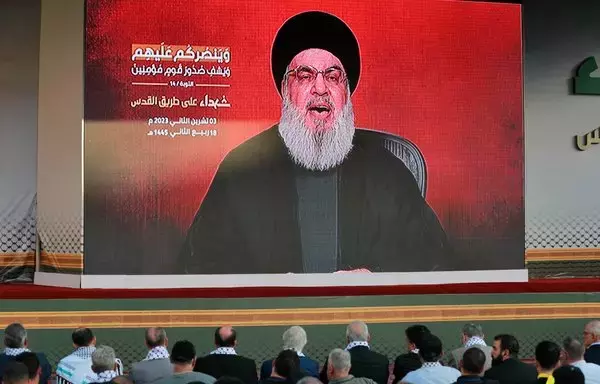 Supporters of Lebanese Hizbullah watch a televised speech by party leader Hassan Nasrallah in Beirut's southern suburb on November 3. [Ahmad al-Rubaye/AFP]