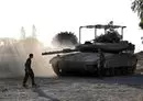 
Israeli tanks and bulldozers deployed along the Israel-Gaza border on November 4. [Yuri Cortez/AFP]        