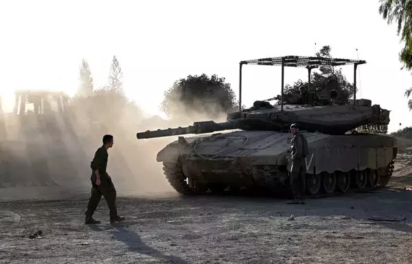 Israeli tanks and bulldozers deployed along the Israel-Gaza border on November 4. [Yuri Cortez/AFP]