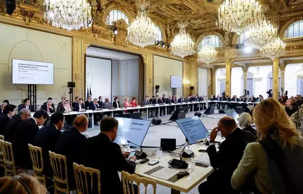 French President Emmanuel Macron (C, gray suit) November 9 in Paris speaks next to representatives from countries, international organizations, businesses, development banks and NGOs during an international humanitarian conference for civilians in Gaza. [Ludovic Marin/Pool/AFP]