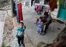 
Syrian refugee Hassan al-Ali, 26, who was separated from his pregnant wife on a migrant boat heading to Cyprus, plays with their children Khaled, 3, and Fatima, 2, at their house in Ain el-Tefaha, east of Beirut, on September 23, 2021. [Joseph Eid/AFP]        