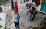 
Syrian refugee Hassan al-Ali, 26, who was separated from his pregnant wife on a migrant boat heading to Cyprus, plays with their children Khaled, 3, and Fatima, 2, at their house in Ain el-Tefaha, east of Beirut, on September 23, 2021. [Joseph Eid/AFP]        