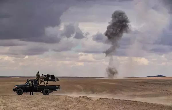 Members of the Syrian Democratic Forces and the US-led international coalition take part in military exercises in the eastern province of Deir Ezzor on March 25, 2022. [Delil Souleiman/AFP]