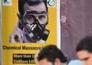 
A poster depicting Syria's president Bashar al-Assad in a gas mask is seen in the opposition-held northern city of Afrin on August 20, marking the 10-year anniversary of chemical attacks that killed over 1,400 people in Eastern Ghouta, outside Damascus. [Rami al-Sayed/AFP]        