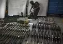 
An Israeli soldier stands with weapons recovered from areas Hamas targeted in its October 7 terrorist attack on southern Israel, on October 26. [Aris Messinis/AFP]        