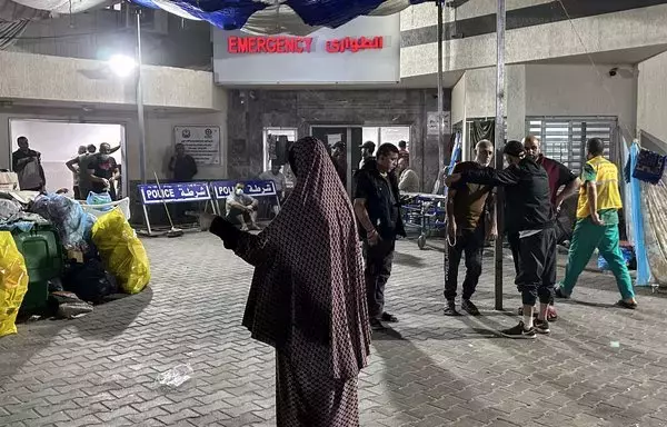 People stand outside the emergency ward of Al-Shifa Hospital in Gaza City on November 10, amid ongoing battles between Israel and Hamas. [AFP]