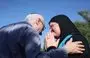 
Nir (L), the brother of killed Israeli-Canadian peace activist Vivian Silver, greets Arab-Israeli Ghadir Hani, a fellow peace activist from Acre, during a memorial service for Silver in Kibbutz Gezer, in central Israel on November 16. [Oren Ziv/AFP]        