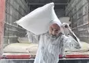 
A worker at a flour warehouse in Beirut supplies a bakery with bags of flour before the stock dwindles. [Ziyad Hatem/Al- Fassel]        